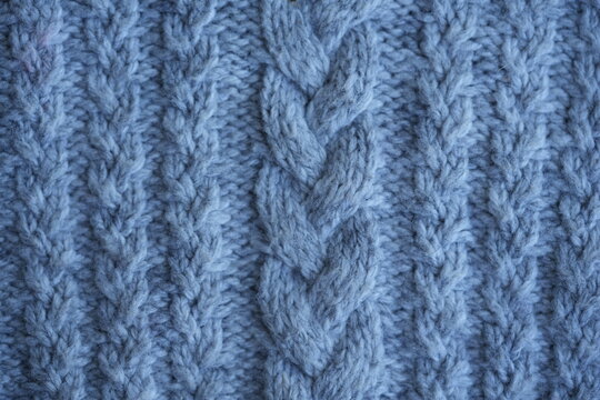 Gray cable knit fabric texture background soft gray knitted fabric with a classic cable knit pattern. Cozy textured yarn with braided stitches creates a warm background ideal for sweaters, winter fash