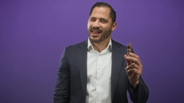 Man holding a chess king piece near face with right hand, tongue out and smirk in studio; strategy playful.