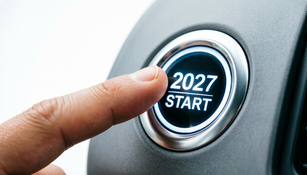 Finger pressing 2027 start button on car dashboard, conceptual new year launch button, future planning and business strategy concept isolated on White Background