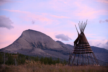 Pastel Sunset Over Mountain Peak with Distant Teepee Frame, Glacier National Park, Montana © davidmarx
