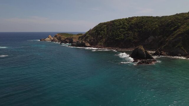 Aerial view of Punta Cometa coastline with turquoise ocean and rocky shore, Oaxaca, Mexico