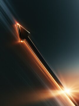 Arrow on dark charcoal background with gold light streaks and bright flare, showing growth, direction, progress, strategy, opportunity, and finance for business pitch use.