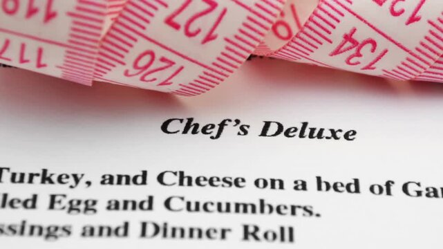 Measuring Tape on Recipe Document Representing Portion Size and Nutrition Measurement
