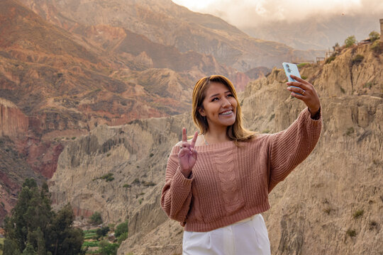 A Latina woman traveling and taking a selfie in the Mallasa region in the department of La Paz, Bolivia - travel concept