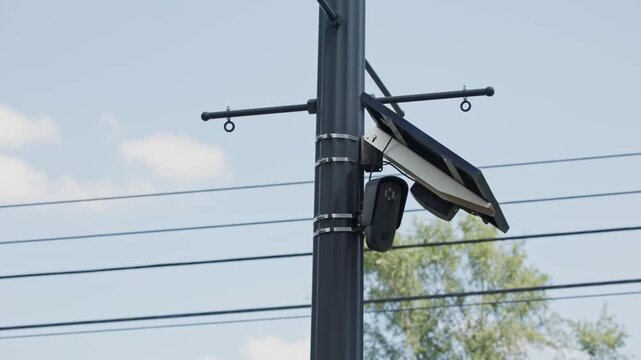 ALPR camera FLOCK safety surveillance for high-speed, computer-controlled systems and automatic license plate recognition on road pole mount to detect car speed in slow motion powered by solar panel