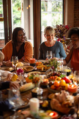 Naklejka premium Joyful diverse friends dining together.