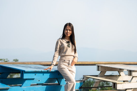 Woman relaxing beside a scenic waterfront