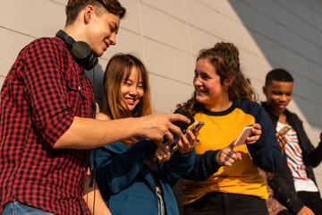 Teens enjoying social media outdoors