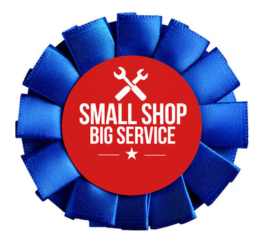 Blue rosette ribbon with a red center displaying small shop big service text and wrench icons