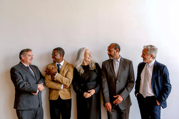 Group of diverse professionals in formal attire standing together.