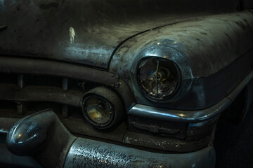 A Detailed Macro View of a Rusty Vintage Cadillac Headlight and Broken Grille © Nicolas GR