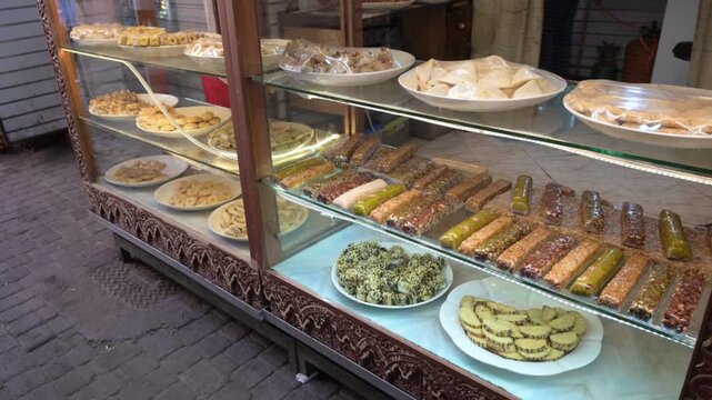 Marrakech, morocco. August 8, 2026. Display case filled with traditional moroccan pastries and sweets for sale. Assorted biscuits, nougat, and delicacies in a shop in marrakech's medina souk