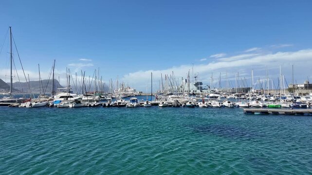 Simon's Town Western Cape South Africa. 13.08.2026. Video.  A wide shot of a bustling marina in Simon's Town, filled with sailboats and yachts.