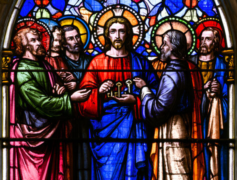 Jesus confers Saint Peter's authority in the church's stained glass artwork. The apostles witness this biblical occurrence in the colorful holy window. The divine scene emphasizes faith.