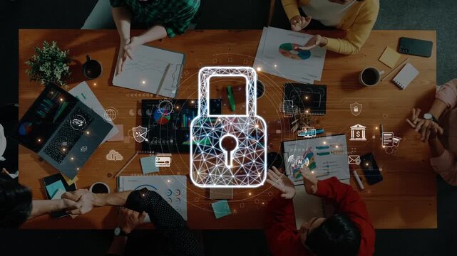 A diverse team engages in a collaborative meeting around a table, emphasizing the importance of digital security and data protection with visual symbols and technology. Raster