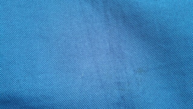 Bright blue fabric texture showing detailed woven synthetic nylon material pattern