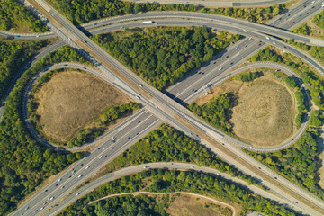Fototapeta premium Aerial View of Highway Intersection With Cars Driving on Asphalt Roads During Daytime