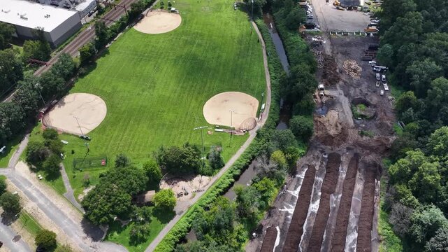 Orbiting aerial view around Cameron Field, railway tracks and South Orange construction site