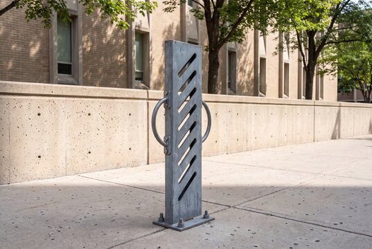 Empty metal bicycle rack on a concrete sidewalk