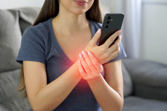 Smartphone Syndrome Concept. Unrecognizable Young Woman Holds her Painful Wrist.