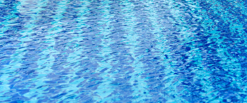Turquoise paradise shiny outdoors party in luxury hotel. Summer Outdoors lifestyle tourist vacation background swimming pool. Poolside background Blue swimmimg pool reflection ripple wave underwater