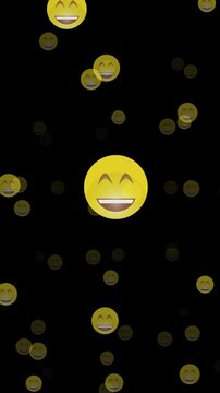 Vertical video featuring floating smiling emojis on black background