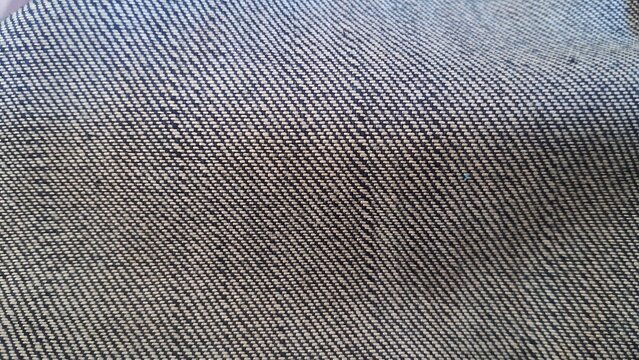 Dark blue denim fabric texture showing detailed diagonal twill weave pattern