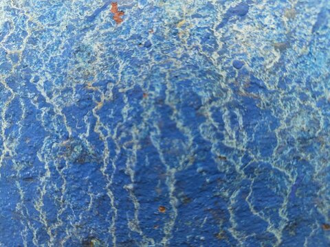Cracked blue paint with root-like white lines, weathered abstract texture
