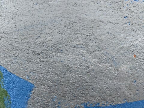 Rough grey concrete texture with blue and orange accents, minimal abstract background