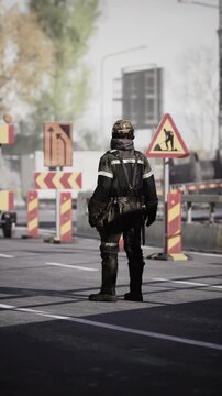 A road worker stands calmly in a bustling city, navigating traffic near construction signs. The sun shines brightly as vehicles pass, illustrating a typical day on the job in urban infrastructure.