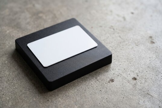 Access card reader with blank white rfid card on concrete background for modern security system concept