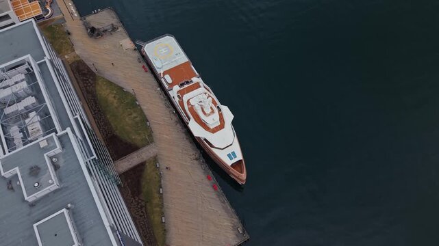 Experience the stunning view of La Datcha, a magnificent expedition yacht, gracefully anchored at the bustling Halifax waterfront surrounded by the city&rsquo;s charm