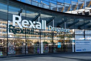 Fototapeta premium Toronto, ON, Canada - August 21, 2026: A Rexall Drugstore in Toronto, ON, Canada. Rexall Pharmacy Group ULC is a chain of retail pharmacies in Canada.