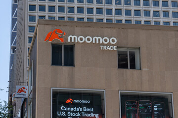 Fototapeta premium Toronto, ON, Canada - August 21, 2026: The flagship store of Moomoo Financial Canada on Bloor Street West in downtown Toronto, ON, Canada. Moomoo is a Hong Kong global retail stock brokerage and onli