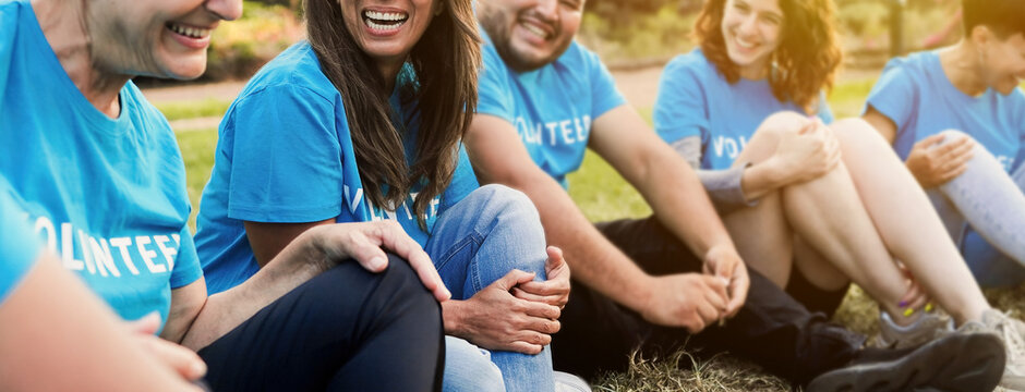 Happy group of volunteer people celebrating together outdoor - Teamwork and charity support concept