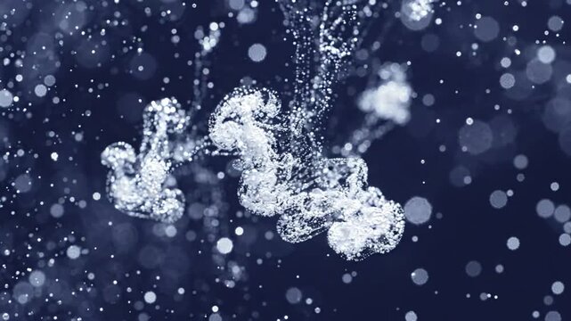 White ink flowing in water creating abstract clouds on dark background