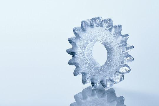 Gear cog carved from clear ice surreal frozen concept