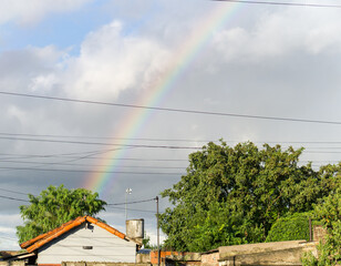 Fototapeta premium Rainbow Over a Residential Neighborhood After Rain