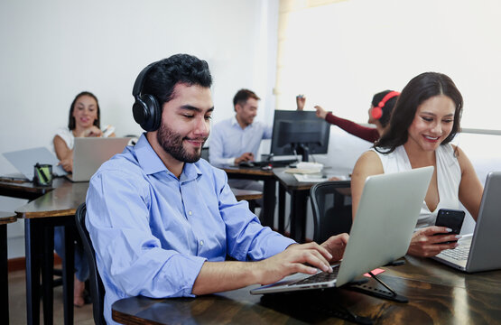 young latin business man using laptop and working at office in Mexico Latin America. Hispanic male employee at workplace