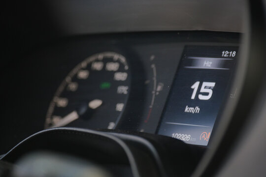 Driver's view of speedometer indicating 15 kilometers per hour