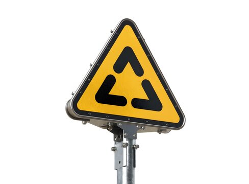 Triangular yellow traffic sign on metal post isolated on white background. Road hazard warning and navigation alert concept. Yellow sign displaying black roundabout arrow symbol