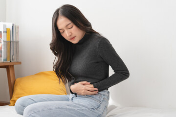 Fototapeta premium close up woman suffering stomach pain from food poisoning.