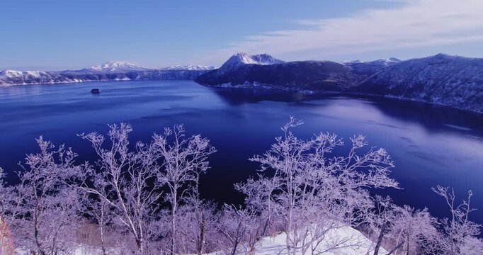 Frost-covered trees overlooking Lake Mashu in winter, Hokkaido, Japan