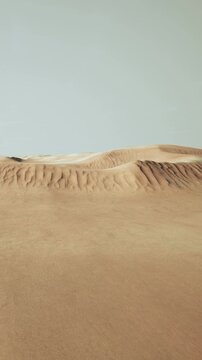 The scene shows vast sand dunes in a desert landscape. The sun shines brightly above, creating a warm atmosphere. The dunes have smooth curves and contours.