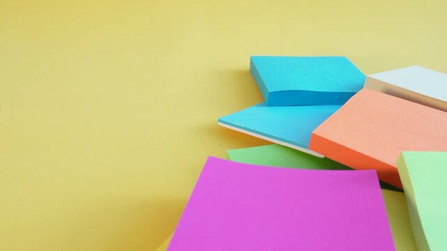 Vibrant sticky notes arranged in soft, overlapping piles
