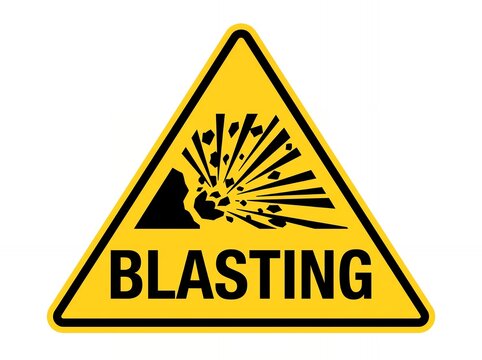 Yellow triangular warning sign indicating active blasting and explosion hazard on site