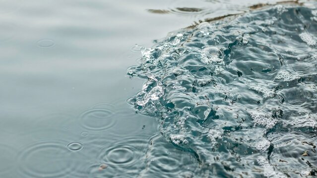 Clear flowing water surface with gentle ripples and splashing current