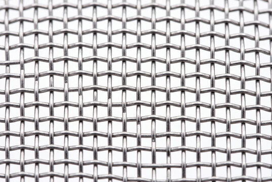 Stainless steel woven mesh texture ultra macro with interlocking metallic threads, precision industrial material for architecture brand and tech design