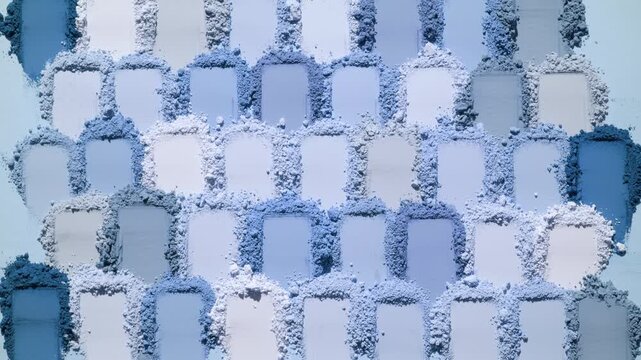 From above view of a multitude of blue smeared powder heaps lit with orbiting directional light casting dynamic shadows