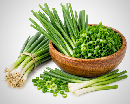 a pile of scallions in a wooden bowl